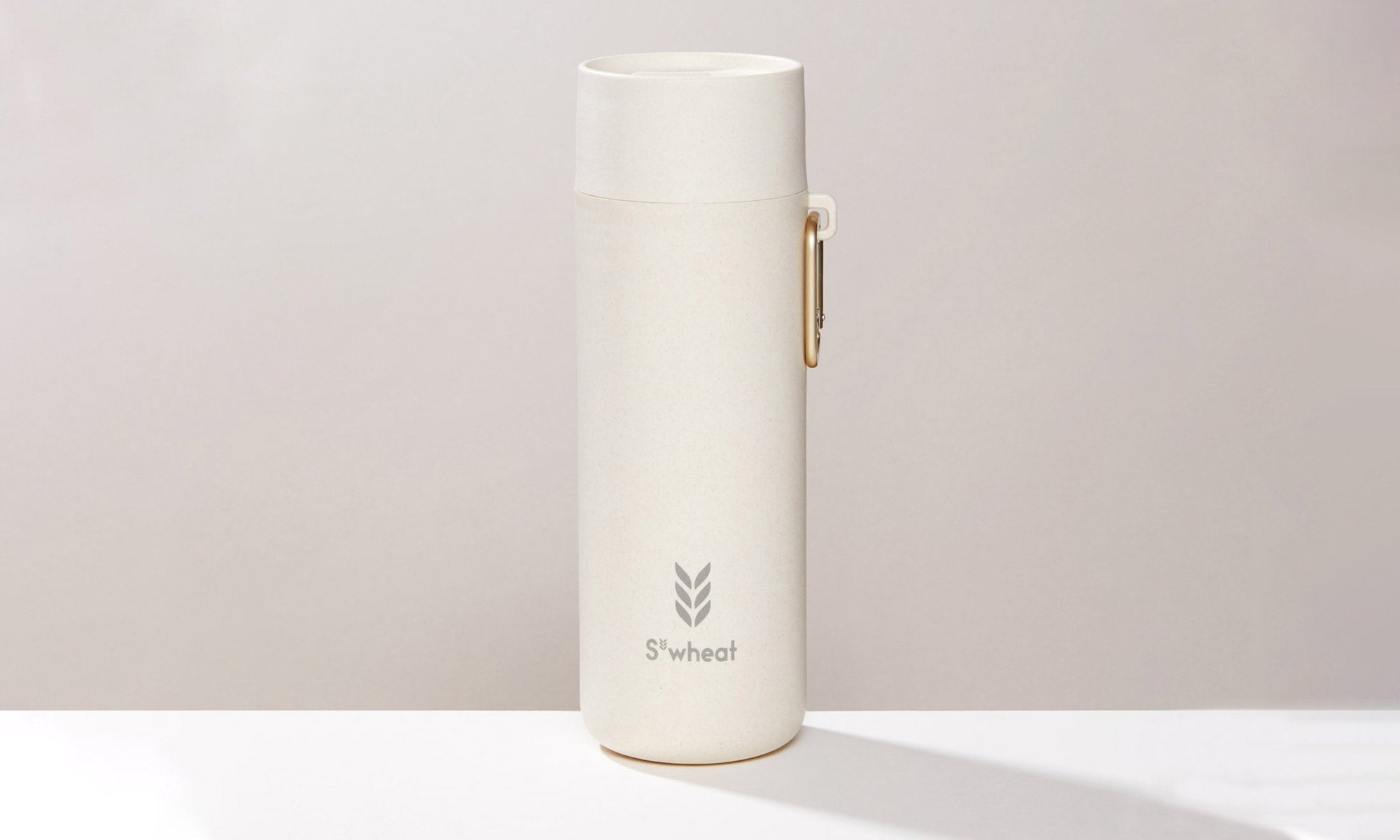 Reusable water bottle in oat colour with gold carry clip